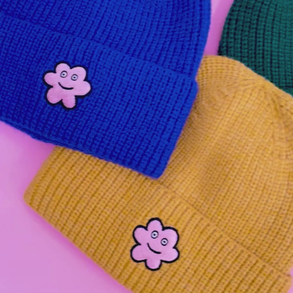 Video of a person putting on and wearing all colours of the lambswool blend happy luci knit beanie. 