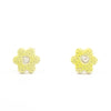 A pair of handmade ceramic stud earrings shaped like small yellow buttercup flowers, with tiny dotted details and a carved centre. Finished with sterling silver posts.