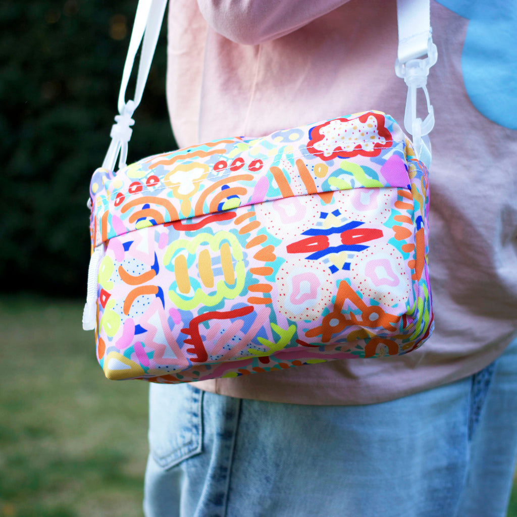 Shoulder view of the Coral everyday bag. Bright multicoloured impressionistic undersea patterns. 