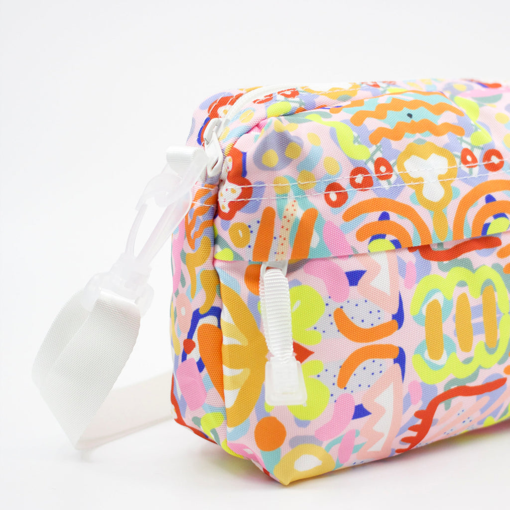 Side and strap view of the Coral everyday bag. Bright multicoloured impressionistic undersea patterns. 
