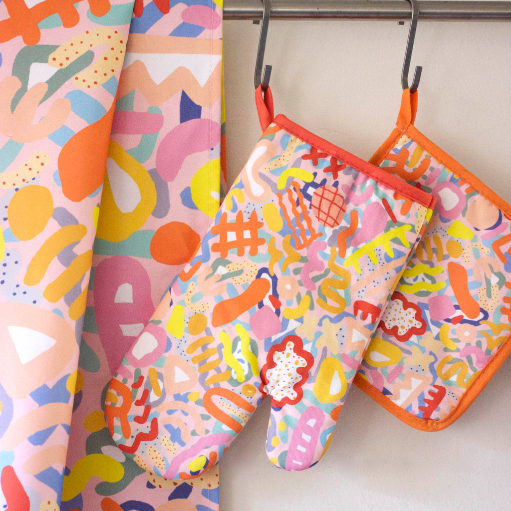 A picture of the set of Coral prints on a tea towel, pot holder, and oven mitt. An impressionist interpretation of undersea microscopic life in a coral reef. 