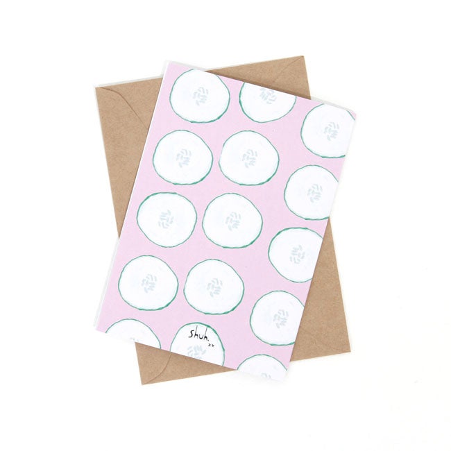 Back view of the cool as a cucumber print. Repeated cucumber slices over a pink background. 