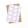 Front view of the cool as a cucumber print. Repeated cucumber slices over a pink background. 