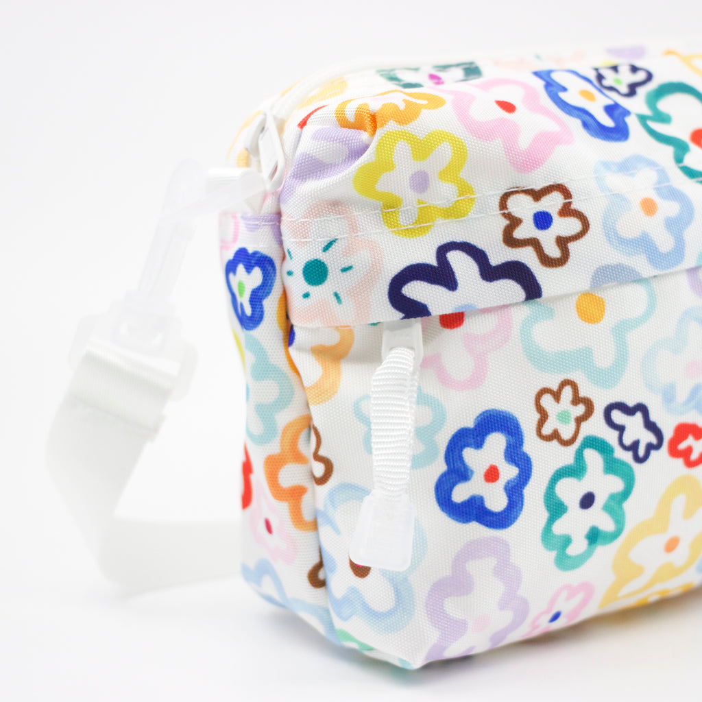 Side view of the Daisy everyday bag. Multicoloured daisy illustrations on a white background. 