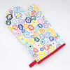 A top view of the Daisy oven mitt. This bright and fun design features illustrated multi-coloured daisies on a white background.