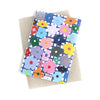 Back view of the flower print card. Multicoloured flowers on a white and blue chequered background.