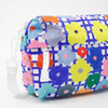 Strap view of the flower everyday bag. Bright flower illustrations over a blue and white checkered background.