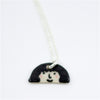 Closeup view of a Sterling silver necklace featuring a hand-painted ceramic pendant with a playful face and fuzzy hairstyle, displayed on a white background.