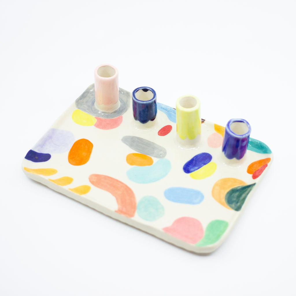 Rotated top view of the Grande trinket dish. Multicolour abstract paint. 4 spouts to hold rings, and put flowers in. 