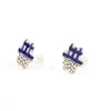 Side view of a pair of handmade ceramic stud earrings in a flower-like shape with indigo check pattern on top and black speckles on the bottom. Sterling silver studs. Designed by shuh.
