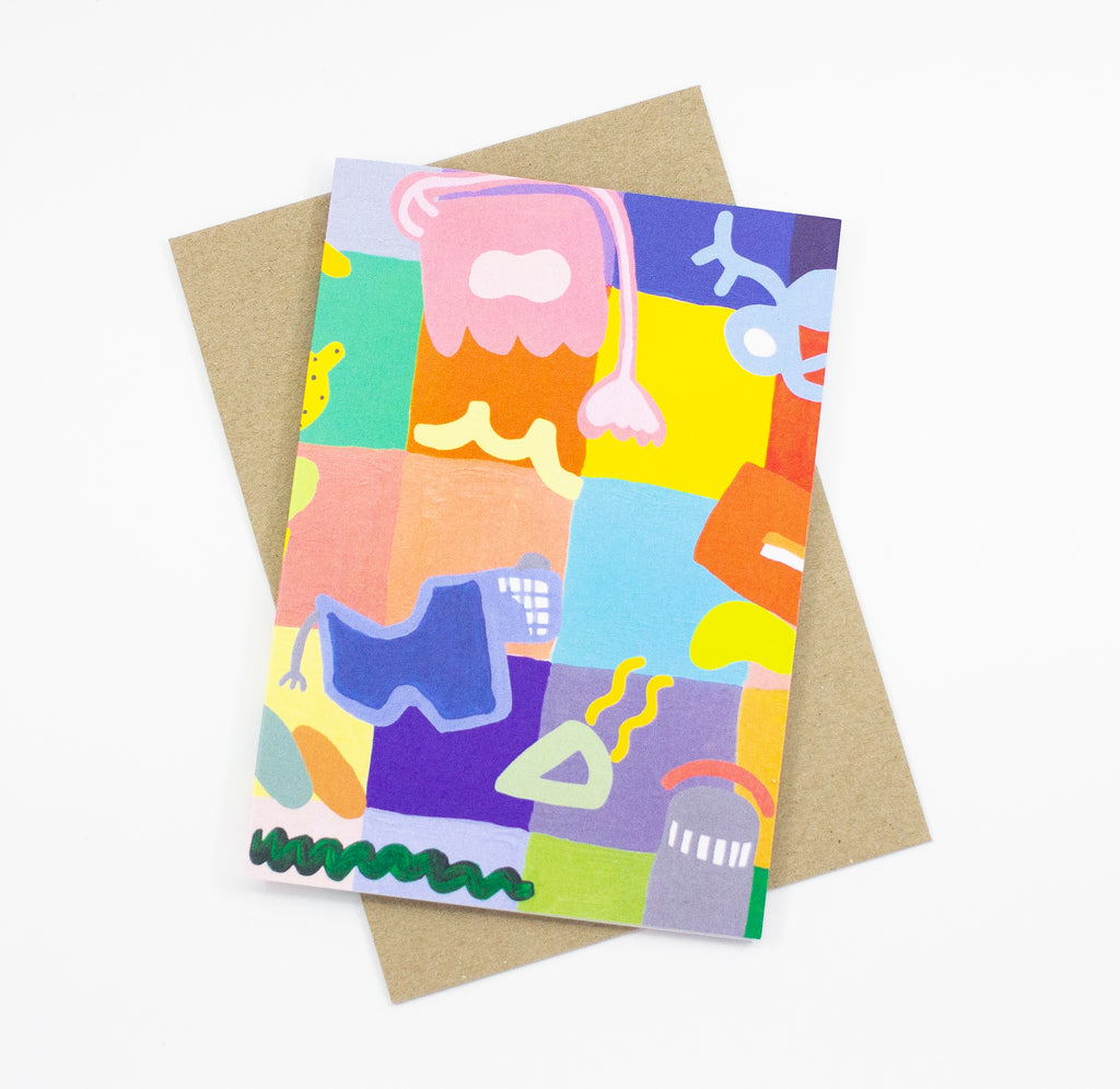 Front view of the Joy Mat print card. Abstract shapes, characters, and bright colours over a background of multicoloured sqaures. 