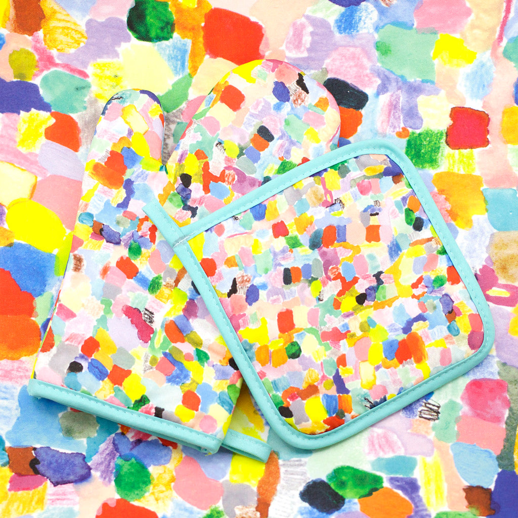 A top view of the Landscape oven mitt and pot holder. An impressionist representation of a mountain view. Multi coloured and abstract. 