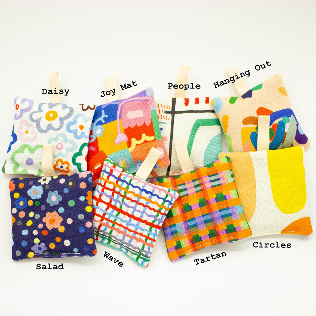 A Top view of the shuh lavender sachet collection. Featuring 8 different prints. Each print has the name of the print above or below. 