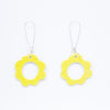 Two ceramic drop earrings, with sterling silver hooks. Ceramic pendants are circular flower shaped with a hollow centre. Hand painted yellow. 