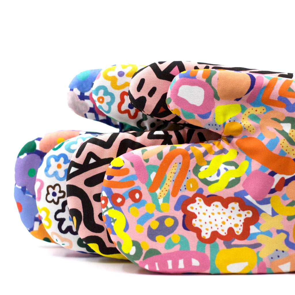 A side view of the set of shuh. oven mitts. With 4 different designs. 