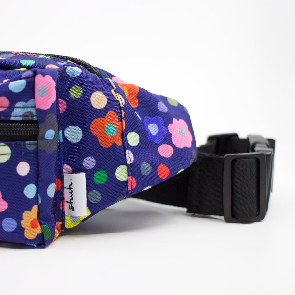 Tag view of the Salad bum bag. Print has multicoloured flowers on a navy background.