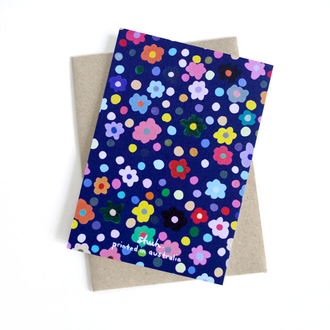 Front view of the Salad card. Multicoloured flower heads and polka dots on a navy background.