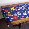 Top view of the Salad table runner. Bold flower patterns and polka dots, with all shuh.’s favourite colours, on a navy background