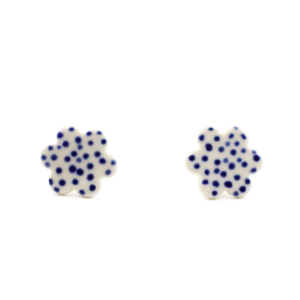 Pair of handmade ceramic stud earrings shaped like small clouds with an indigo blue dotted pattern on white. Designed by shuh.