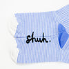 View of the sole of the shuh. girl socks. Featuring the iconic shuh. girl and a blue and white striped pattern, these socks are designed to bring fun and imagination to your feet