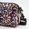 Side view of the sweet everyday bag.  Pink background with black designs. 