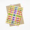 Back view of the Tartan print card. Multicoloured checkered print, orange, purple, green, yellow, blue, lavender, and pink. 