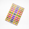 Back view of the Tartan notebook, with multicoloured tartan print. Purple, blue, green, yellow, and orange. 