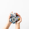 A picture of two hands holding the entire collection of shuh. washi tapes. 