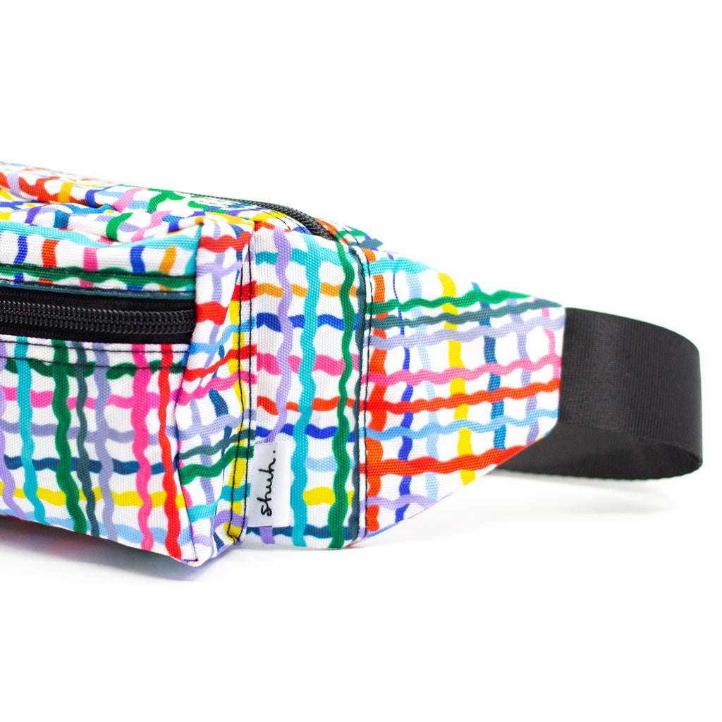 Side view of wave bumbag. Pattern features wavy multicoloured lines on a black background. 