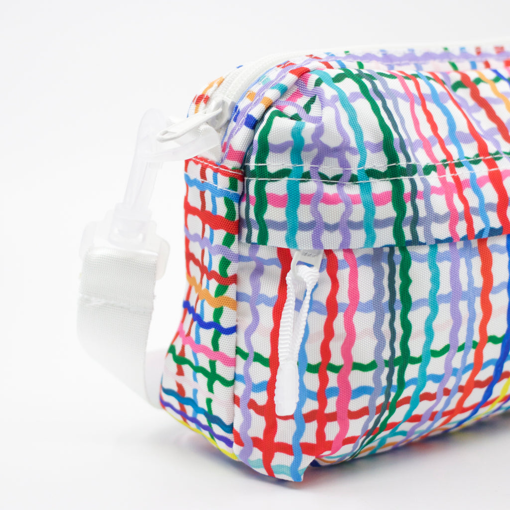 Strap view of Wave everyday bag. Multicoloured wavy lines on a white background.