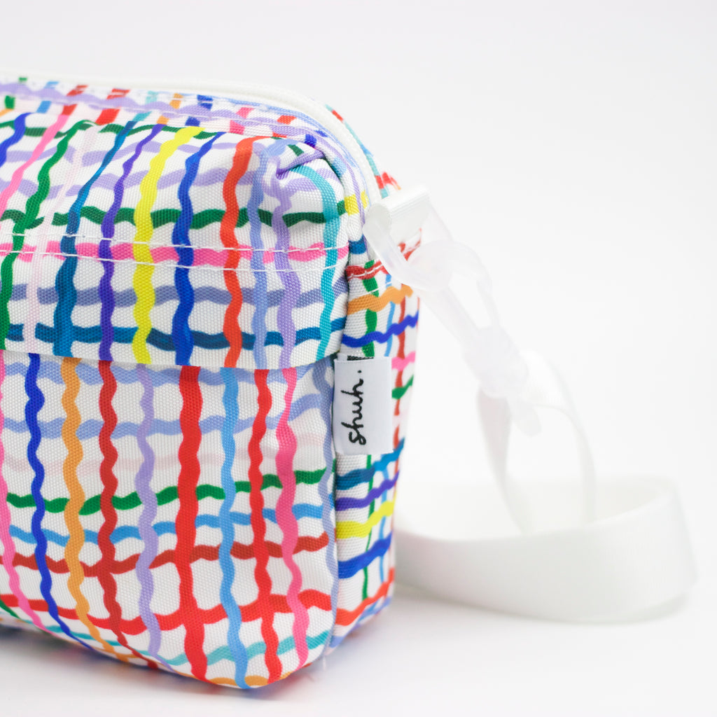 Tag view of Wave everyday bag. Multicoloured wavy lines on a white background.