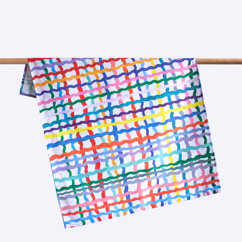 Wave cotton tea towel. Multicoloured wavy stripes on a white background. 